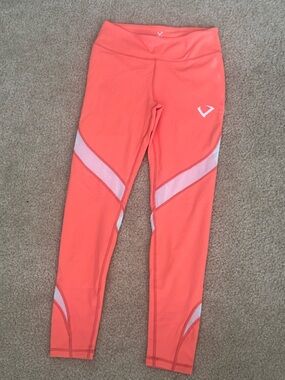 Vibrant Orange Athletic Leggings with White Mesh Paneling